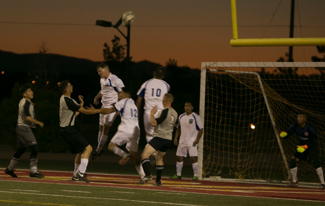 A Marine from the Headquarters Battalion team, head butts the ball during an intramural soccer game against the Marine Corps Communication-Electronics School team at Felix Field aboard Marine Corps Air Ground Combat Center, Twentynine Palms, Calif., May 1, 2017. Marine Corps Community Services, in partnership with Semper Fit, hosts an intramural soccer league for units aboard the installation. HQBN came out victorious with a score of 3-1.  (U.S. Marine Corps photo by Cpl. Medina Ayala-Lo)