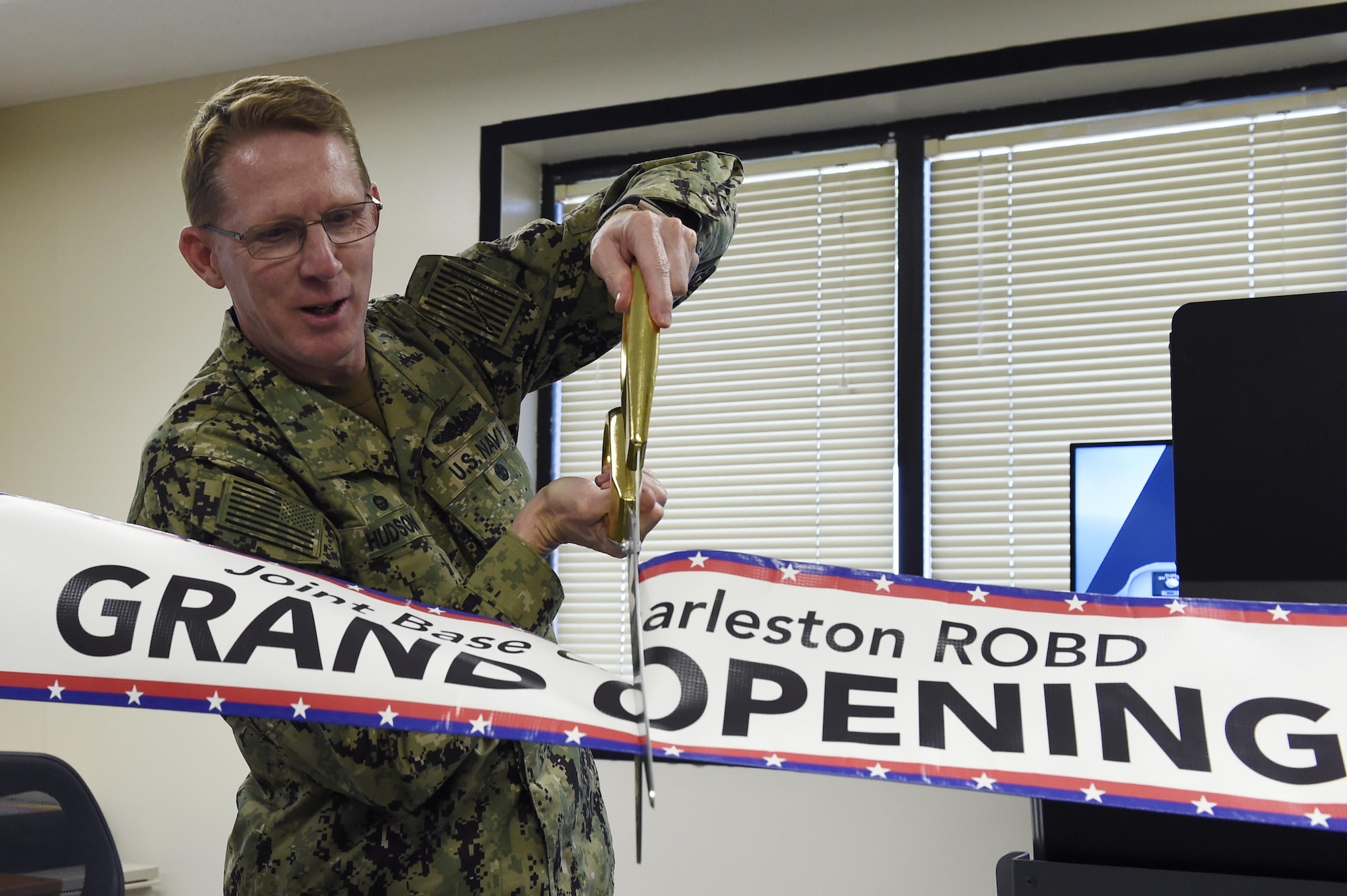 U.S. Navy Capt. Robert Hudson, Joint Base Charleston deputy commander, cuts the ribbon to mark the beginning of the Reduced Oxygen Breathing Device operations May 2, 2017. Because the device is available locally, 1,200 Airmen can receive onset hypoxia training annually without the added requirement of traveling to an installation with an altitude chamber. ROBD training allows aviators and aircrew to experience hypoxia without the threat of decompression sickness associated with the altitude chamber.