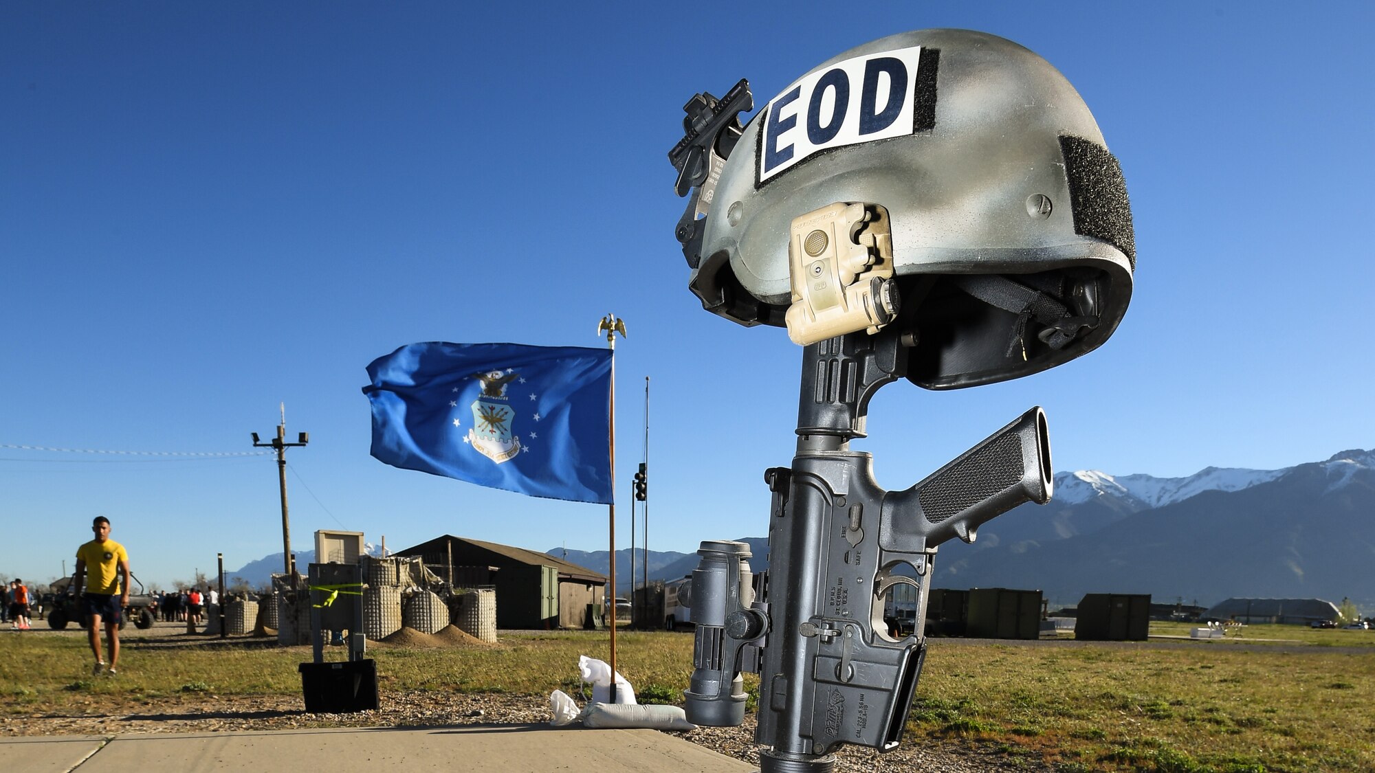 A battlefield cross and Air Force flag are on display May 5 at Hill Air Force Base, Utah, during a mud run hosted by the 775th Explosive Ordnance Disposal Flight. The mud run was part of National Explosive Ordnance Disposal Day and EOD technicians from all across the west coast—along with civilian, active-duty and reserve personnel from Hill AFB—paid their respects with the blood, sweat and tears generated by effort focused on the event. (U.S. Air Force/R. Nial Bradshaw)