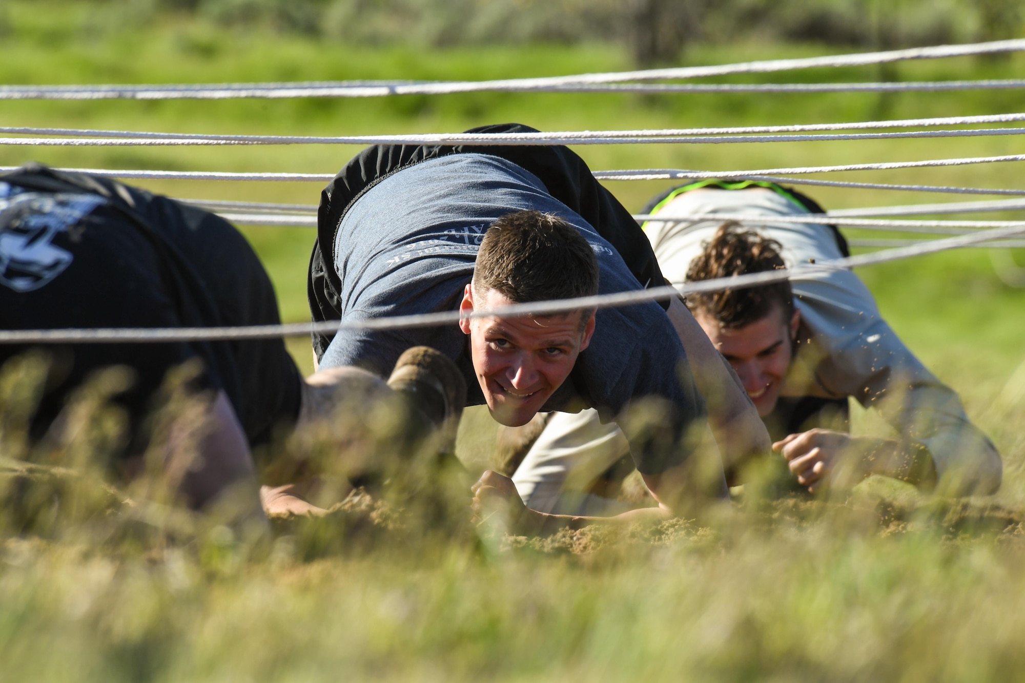 Participants navigate an obstacle May 5 at Hill Air Force Base, Utah, during a mud run hosted by the 775th Explosive Ordnance Disposal Flight. The mud run was part of National Explosive Ordnance Disposal Day and EOD technicians from all across the west coast—along with civilian, active-duty and reserve personnel from Hill AFB—paid their respects with the blood, sweat and tears generated by effort focused on the event. (U.S. Air Force/R. Nial Bradshaw)