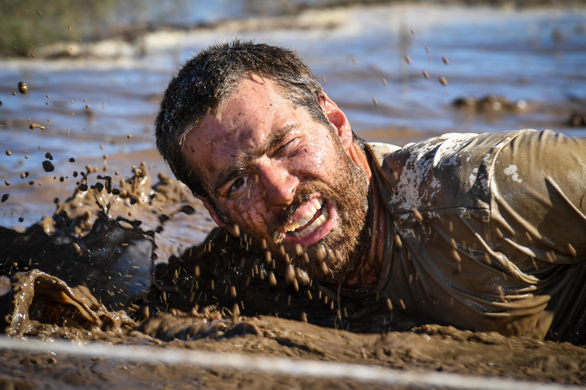 A participant navigates an obstacle May 5 at Hill Air Force Base, Utah, during a mud run hosted by the 775th Explosive Ordnance Disposal Flight. The mud run was part of National Explosive Ordnance Disposal Day and EOD technicians from all across the west coast—along with civilian, active-duty and reserve personnel from Hill AFB—paid their respects with the blood, sweat and tears generated by effort focused on the event. (U.S. Air Force/R. Nial Bradshaw)