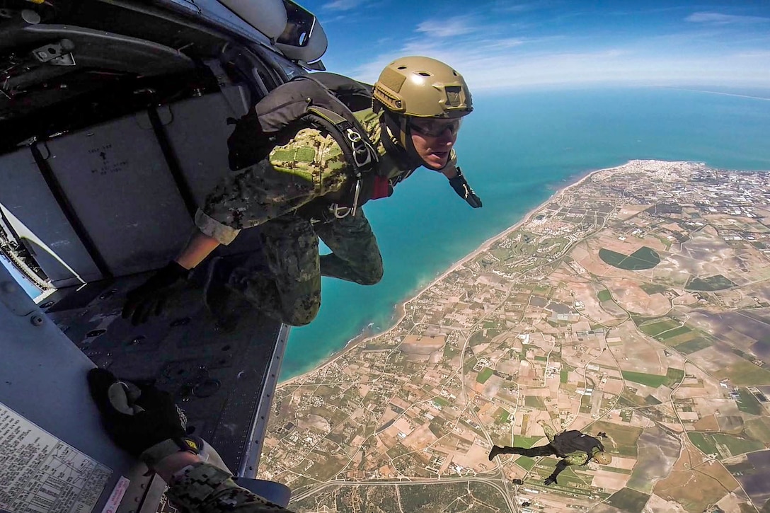 Navy Lt. Cameron Jones prepares to conduct a free-fall jump from an MH-60S Seahawk helicopter at Naval Station Rota, Spain, May 3, 2017. Jones is assigned to Explosive Ordnance Disposal Mobile Unit 8. Navy photo by Senior Chief Petty Officer Brian Stanley