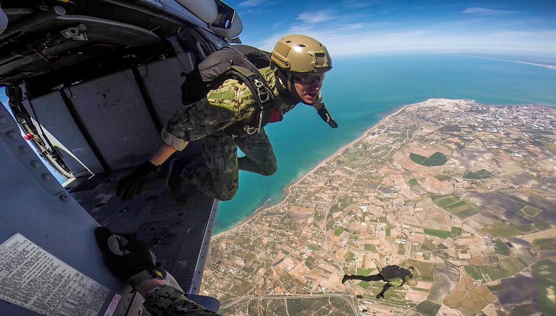 Navy Lt. Cameron Jones prepares to conduct a free-fall jump from an MH-60S Seahawk helicopter at Naval Station Rota, Spain, May 3, 2017. Jones is assigned to Explosive Ordnance Disposal Mobile Unit 8. Navy photo by Senior Chief Petty Officer Brian Stanley 