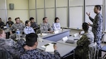 Koku-Jieitai Senior Airman Takashi Shibuya, a 2nd Air Wing Armament Maintenance Squadron armament technician, explains his view of leadership with U.S. and other Japanese Airmen during a 10-day U.S.-Japan Bilateral Career Training at Chitose Air Base, Japan, April 19, 2017. The U.S. and Japanese participants broke out into three groups, each allowed 30 minutes to discuss their top three leadership traits and then present their findings with the rest of the participants. Koku-Jieitai is the traditional term for Japan Air Self Defense Force used by the Japanese. 