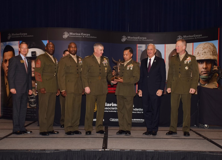 Assistant Commandant of the Marine Corps, Gen. Glenn M. Walters, awards Capt. Ismael Lopez, civil military operations planner for Special Purpose Marine Air-Ground Task Force-Southern Command 17, the 2016 Colonel Justice Marion “Jumping Joe” Chambers Award, at the Marine Corps Association and Foundation Ground Awards Dinner in Arlington, Va., May 4, 2017. Lopez received the “Jumping Joe” Award for his leadership role in the transition of Detachment 4, 4th Tank Battalion to 4th Civil Affairs Group. (Courtesy Photo by Marine Corps Association and Foundation/Released)