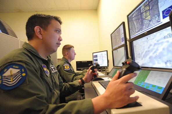 U.S. Air Force Master Sgt. Alex, one of the first Enlisted Pilot Initial Class students, teams up with Lt. Col. Aaron, 558th Flying Training Squadron Remotely Piloted Aircraft Fundamental Course director, during a simulator flight at Joint Base San Antonio-Randolph, Texas, May 4, 2017. Alex is one of the first three enlisted Airmen to graduate from the course, making him on of the service's first enlisted pilots since 1961.  (U.S. Air Force photo by Joel Martinez) 