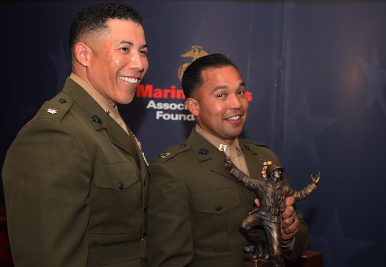 Lt. Col. Esteban Beamon (left), the commander of Detachment 2, 4th Civil Affairs Group, Marine Forces Reserve, stands by Capt. Ismael Lopez (right), the civil military operations planner for Special Purpose Marine Air-Ground Task Force-Southern Command 17, who holds up the 2016 Colonel Justice Marion “Jumping Joe” Chambers Award at the Marine Corps Association and Foundation Ground Awards Dinner in Arlington, Va., May 4, 2017. The award recognized Lopez as the Marine Corps Reserve company grade officer of the year for demonstrating outstanding leadership qualities during the transition of Detachment 4, 4th Tank Battalion to 4th Civil Affairs Group. (Courtesy Photo by Marine Corps Association and Foundation/Released)