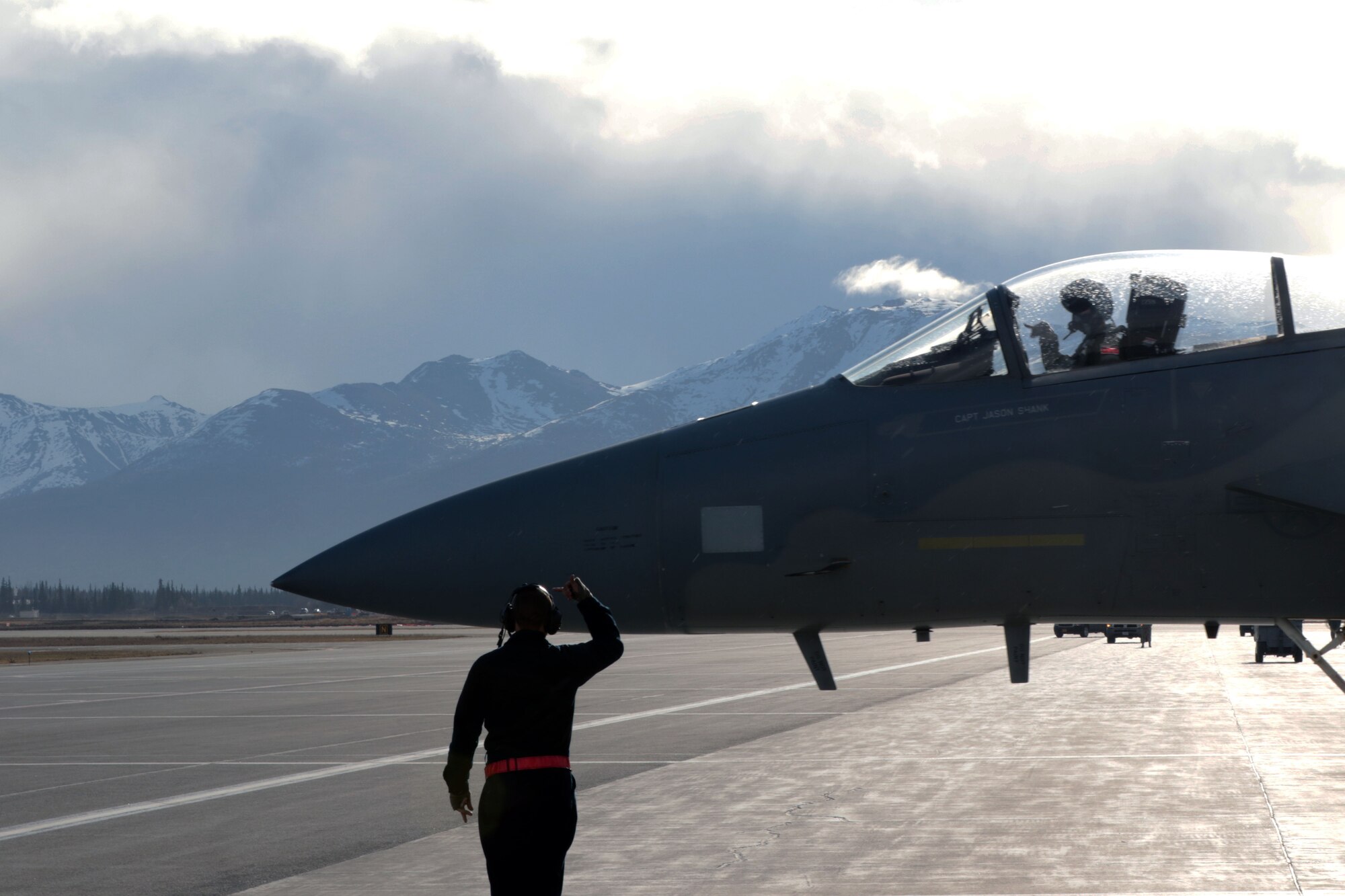Senior Airman Mitchell Donovan, a crew chief with the 67th Fighter Squadron out of Kadena Airbase motions to pilot Air Force Capt. Jason Shank to roll his F-15C Eagle forward during the morning "Go" May 3 as part of Exercise Northern Edge 17. Exercise NE17 is a joint exercise utilizing Alaska's massive range area and is composed of more than 6,000 service members across all service branches.