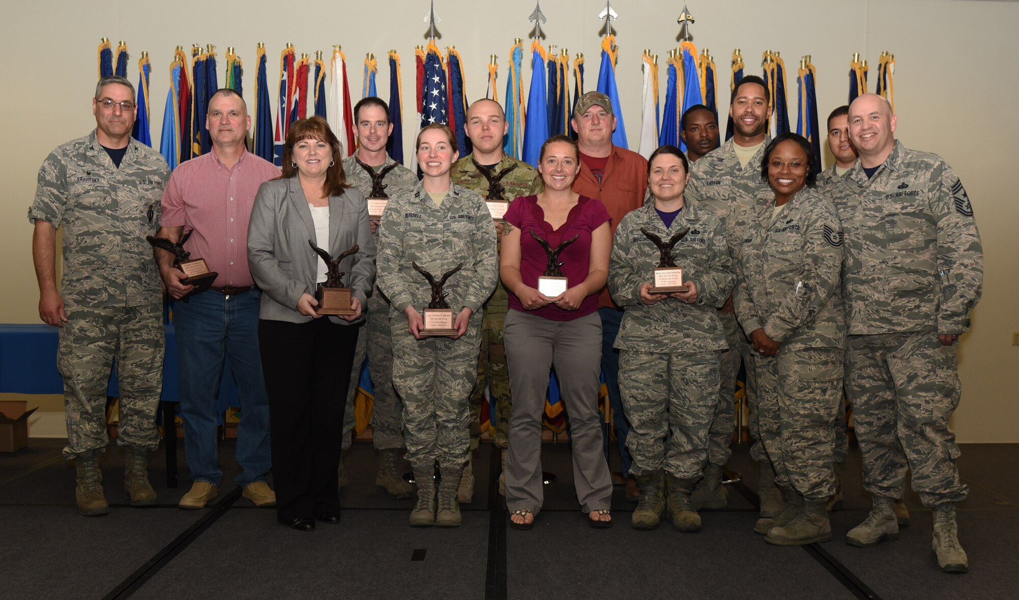 Col. Stephen Kravitsky, 90th Missile Wing commander, and Chief Master Sgt. Jeffery Steagall, 90th Missile Wing command chief, pose with the wing’s first quarter award winners at F.E. Warren Air Force Base, Wyo., May 5, 2017. The wing held a celebration for all the nominees and presented the awards to the winners during a ceremony. (U.S. Air Force photo by Airman 1st Class Breanna Carter)