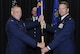 Col. Robert Stanton, left, the 302nd Operations Group commander, passes the  302nd Operations Support Squadron guidon to Lt. Col. Ryan Tanton, right, who assumed command of the squadron during a change of command ceremony, April 1, 2017, at Peterson Air Force Base, Colo. Tanton takes command of the 302nd OSS after serving as the 731st Airlift Squadron chief navigator.  (U.S. Air Force photo/Staff Sgt. Frank Casciotta)