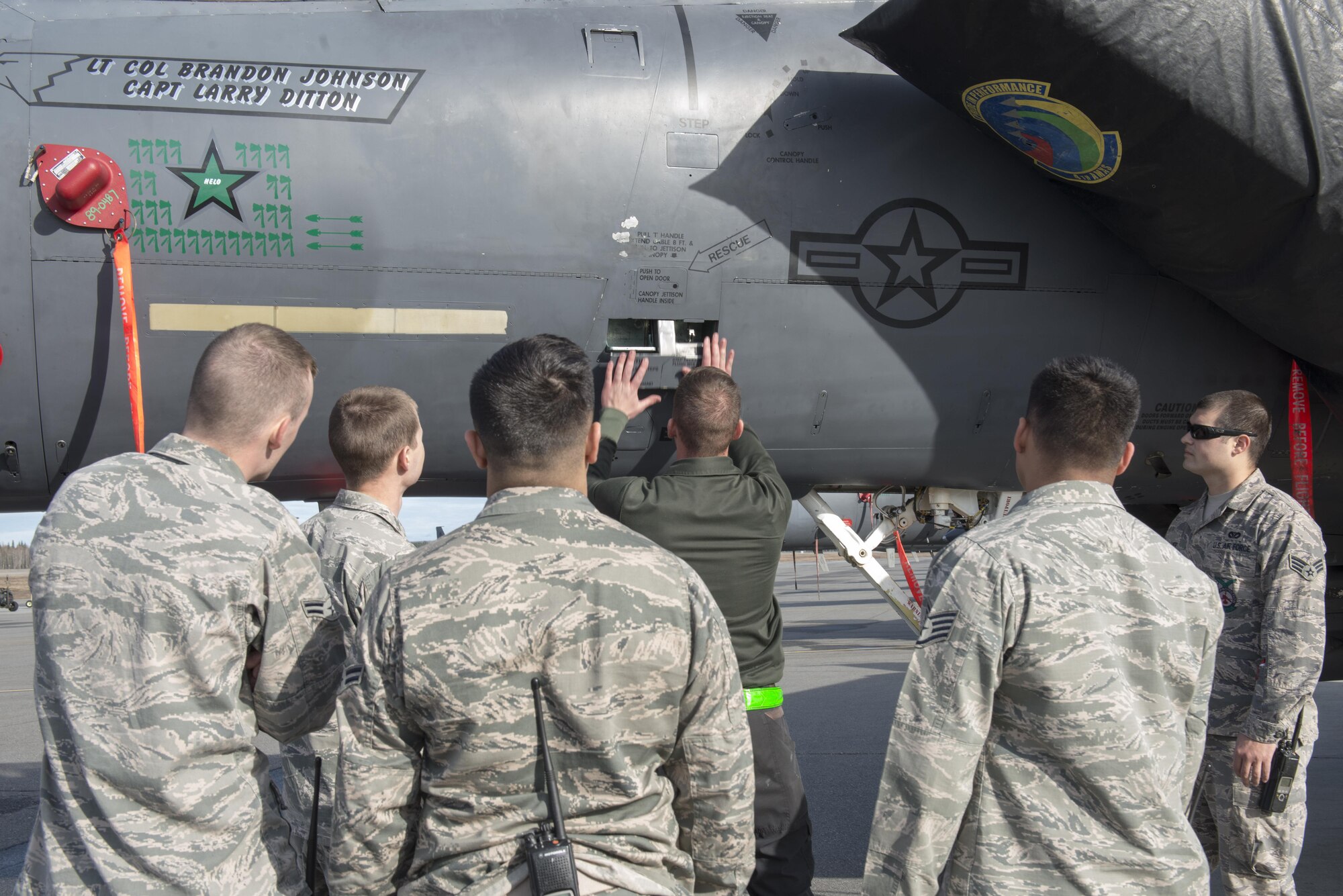 EIELSON AIR FORCE BASE, Alaska – U.S. Air Force Staff Sgt. Ryan Merritt, a 335th Aircraft Maintenance Unit crew chief assigned to Seymour Johnson Air Force Base, N.C., familiarizes members of the 354th Civil Engineer Squadron fire department on an F-15E Strike Eagle dual-role fighter aircraft assigned to the 335th Fighter Squadron, May 4, 2017, during NORTHERN EDGE 2017 (NE17), at Eielson Air Force Base, Alaska. NE17 is Alaska’s premier joint training exercise designed to practice operations, techniques and procedures as well as enhance interoperability among the services. Thousands of participants from all the services, Airmen, Soldiers, Sailors, Marines and Coast Guardsmen from active duty, Reserve and National Guard units are involved. (U.S. Air Force photo/Staff Sgt. Ashley Nicole Taylor)