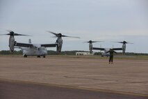 A Marine with Marine Tiltrotor Squadron (VMM) 268 guides an MV-22B Osprey into position after the aircraft landed at Royal Australian Air Force Base Darwin, Australia, April 28, 2017. Four MV-22B Ospreys arrived to begin a deployment to Marine Rotational Force-Darwin 17.2. The Ospreys flew approximately 6,000 miles across the Pacific in 21-hours of flight time. (U.S. Marine Corps photo by Lance Cpl. Damion Hatch)