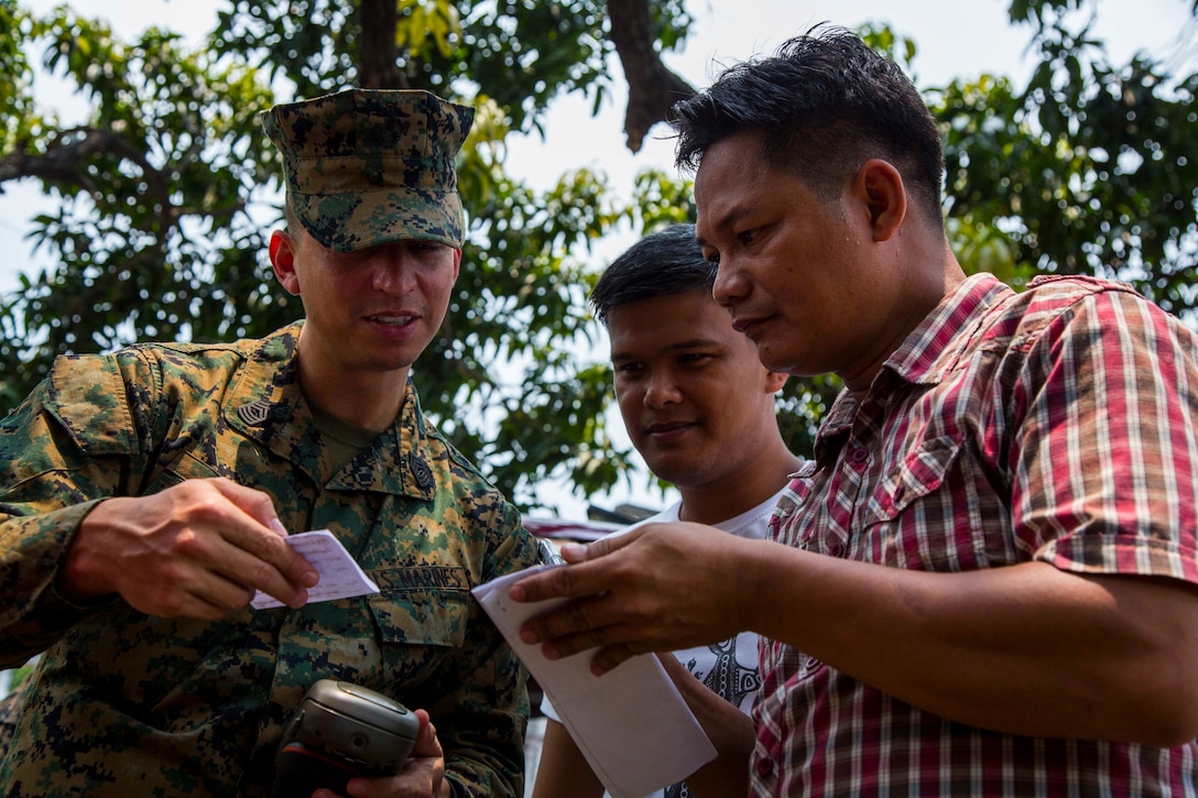 U.S. Marine Master Sgt. Richard Arias, left, and members of the Armed Forces of the Philippines review their plan to create a simulated-expeditionary airstrip during a subject matter expert exchange for Balikatan at Camp Aguinaldo, Quezon City, May 3, 2017. Arias is a geospatial intelligence chief with U.S. Marine Corps Forces, Pacific. Balikatan is an annual U.S.-Philippine bilateral military exercise focused on a variety of missions, including humanitarian assistance and disaster relief, counterterrorism, and other combined military operations.