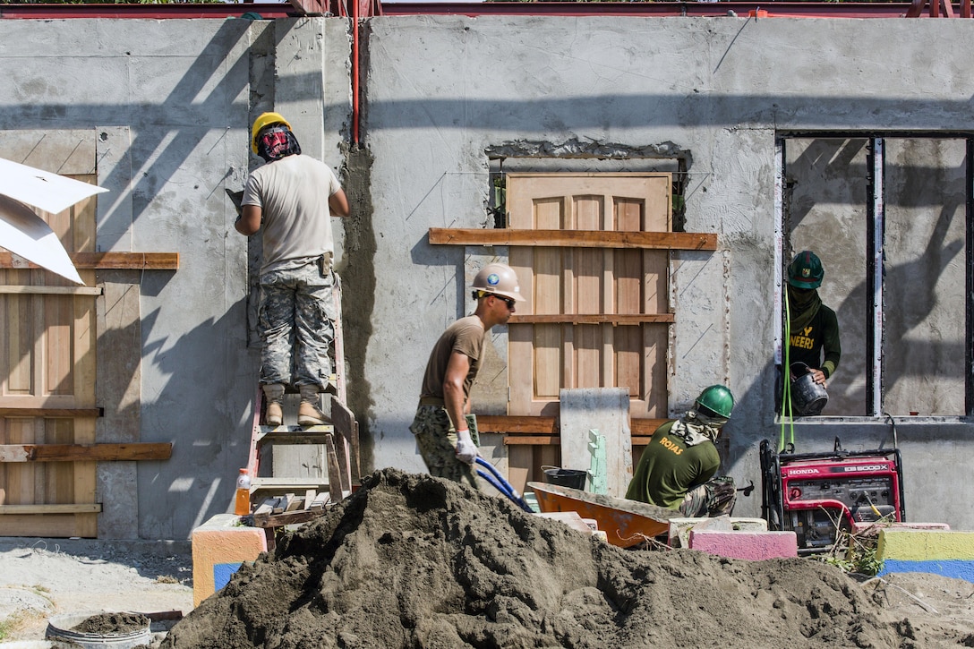 U.S. and Philippine service members build a classroom at Malitbog Elementary School in Tapaz, Philippines, May 1, 2017, as part of a humanitarian civic action project for exercise Balikatan 2017. The U.S. troops are assigned to Naval Mobile Construction Battalion 3 and the 230th Engineer Company, Hawaii Army National Guard. Marine Corps photo by Lance Cpl. Nelson Duenas