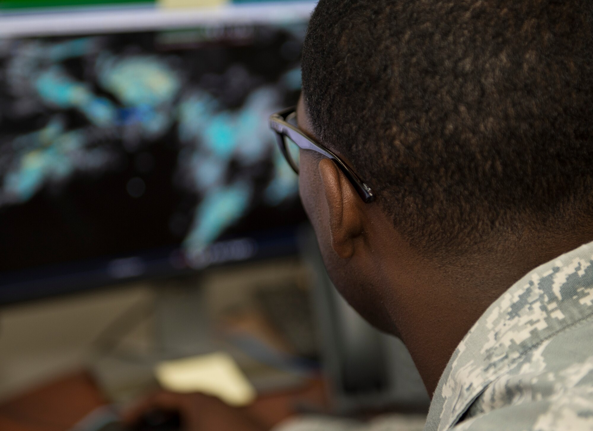U.S. Air Force Master Sgt. Deerick Gray, flight chief with the 379th Expeditionary Operations Support Squadron, Operations Weather Flight reviews radar imagery for the U.S. Central Command area of responsibility at Al Udeid Air Base, Qatar, May 1, 2017. Gray is utilizing the latest information to predict weather patterns, prepare forecasts and communicate weather information to commanders and pilots so their mission goes as planned. (U.S. Air Force photo by Tech. Sgt. Amy M. Lovgren)
