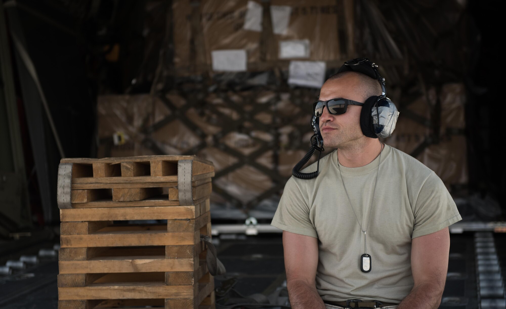 Senior Airman Brian Aviles, a 455th Expeditionary Aircraft Maintenance Squadron crew chief, takes a breather on the ramp of a C-130J Super Hercules at Bagram Airfield, Afghanistan, May 5, 2017. A crew chief ensures the interior and exterior of an aircraft is fully functional. If an issue is discovered on the aircraft that can’t be fixed on the spot, they will request support from specialized maintenance Airmen. (U.S. Air Force photo by Staff Sgt. Benjamin Gonsier)