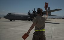 Senior Airman Phillip Vaughn, a 455th Expeditionary Aircraft Maintenance Squadron crew chief, marshals a C-130J Super Hercules at Bagram Airfield, Afghanistan, May 5, 2017. Marshalling is the use of hand signals to direct the pilot where to maneuver the aircraft and when to stop. (U.S. Air Force photo by Staff Sgt. Benjamin Gonsier)