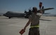 Senior Airman Phillip Vaughn, a 455th Expeditionary Aircraft Maintenance Squadron crew chief, marshals a C-130J Super Hercules at Bagram Airfield, Afghanistan, May 5, 2017. Marshalling is the use of hand signals to direct the pilot where to maneuver the aircraft and when to stop. (U.S. Air Force photo by Staff Sgt. Benjamin Gonsier)