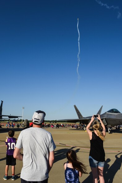 Spectators watch Joe Hollis perform a stall at the 2017 Defenders of Liberty Air Show Twilight Show at Barksdale Air Force Base, La., May 5, 2017. The Twilight Show brought together military members and their families to watch aerial demonstrations, view static displays of aircraft, and more. (U.S. Air Force photo/Senior Airman Luke Hill)