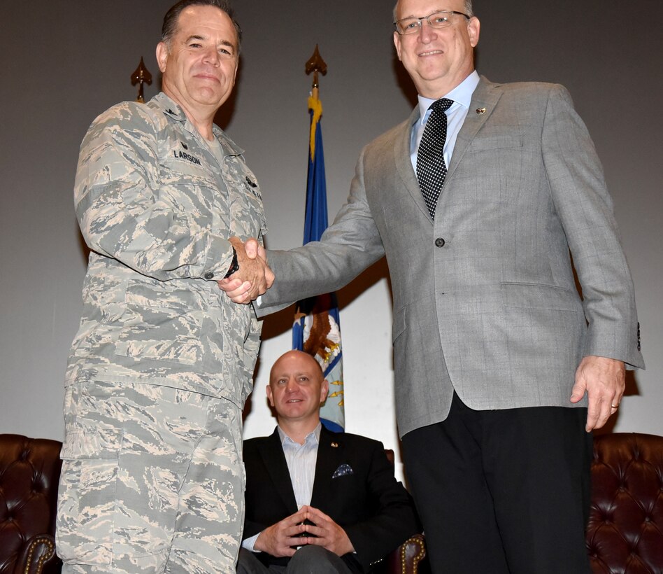 (Left to right) Col. Mark S. Larson, 931st Air Refueling Wing commander, shakes hands with Mayor Jeff Longwell, incoming 931 ARW Honorary Commander, at a Commander's Call during the May Unit Training Assembly May 7, 2017, McConnell Air Force Base, Kan.  In addition to recognizing quarterly award winners, the Commander's Call also included an Honorary Commander Change of Command Ceremony for Longwell, and the outgoing James Havers-Strong.  The honorary commander program spreads awareness of McConnell's mission and builds connections between the base and the community. Havers-Strong has been the 931 ARW HCC since 2014.  (U.S. Air Force photo by Tech. Sgt. Abigail Klein)


