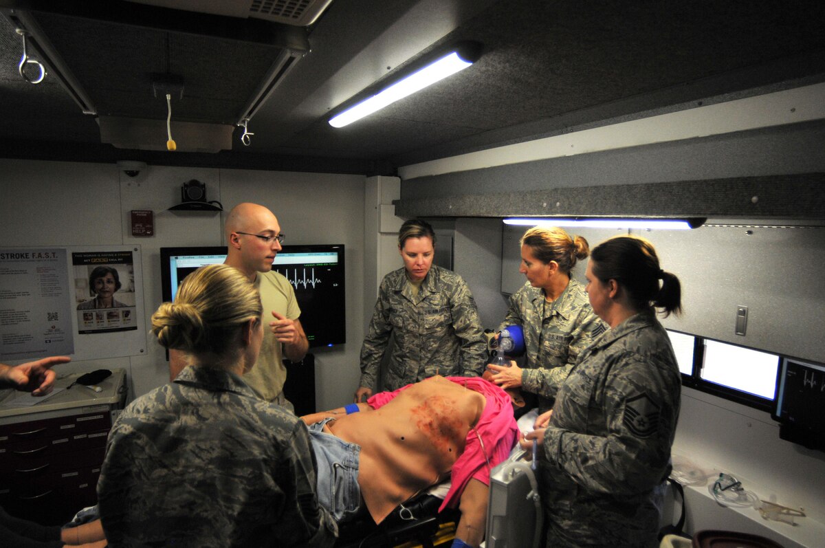 Tech. Sgt. Rachel Vanbeek, 114th Medical Group, aerospace medical technician, assigned tasks to her trauma team during a simulated medical emergency inside the Simulation in Motion South Dakota (SIMSD) vehicle at Joe Foss Field May 6, 2017.  SIMSD was on base to provide highly realistic simulations for the 114th Medical Group medics.  The SDNG will continue to maintain ready and reliable units, and have equipment and facilities, which support both federal and state missions.  (U.S. Air National Guard photo by Master Sgt. Christopher Stewart/Released)