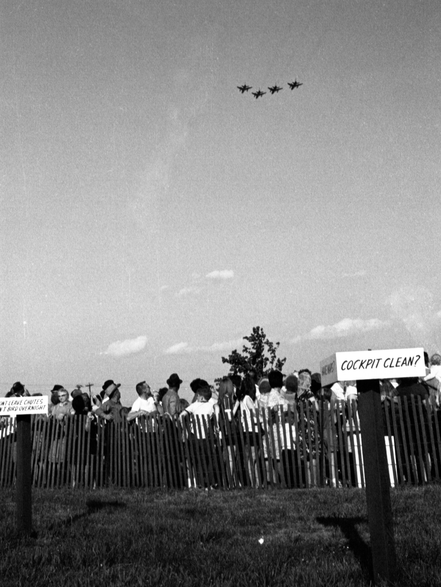 Returning home from the war in Vietnam, four U.S. Air Force F-100 Super Saber, fighter aircraft assigned to the 185th Tactical Fighter Group, fly over a crowd of family members and well-wishers assembled at the Sioux City, Iowa airport on May 14, 1969. The people are gathered in order to welcome them home from their yearlong duty in Phu Cat Airbase in South Vietnam. (U.S. Air National Guard photo/released 185th TFG Photo)