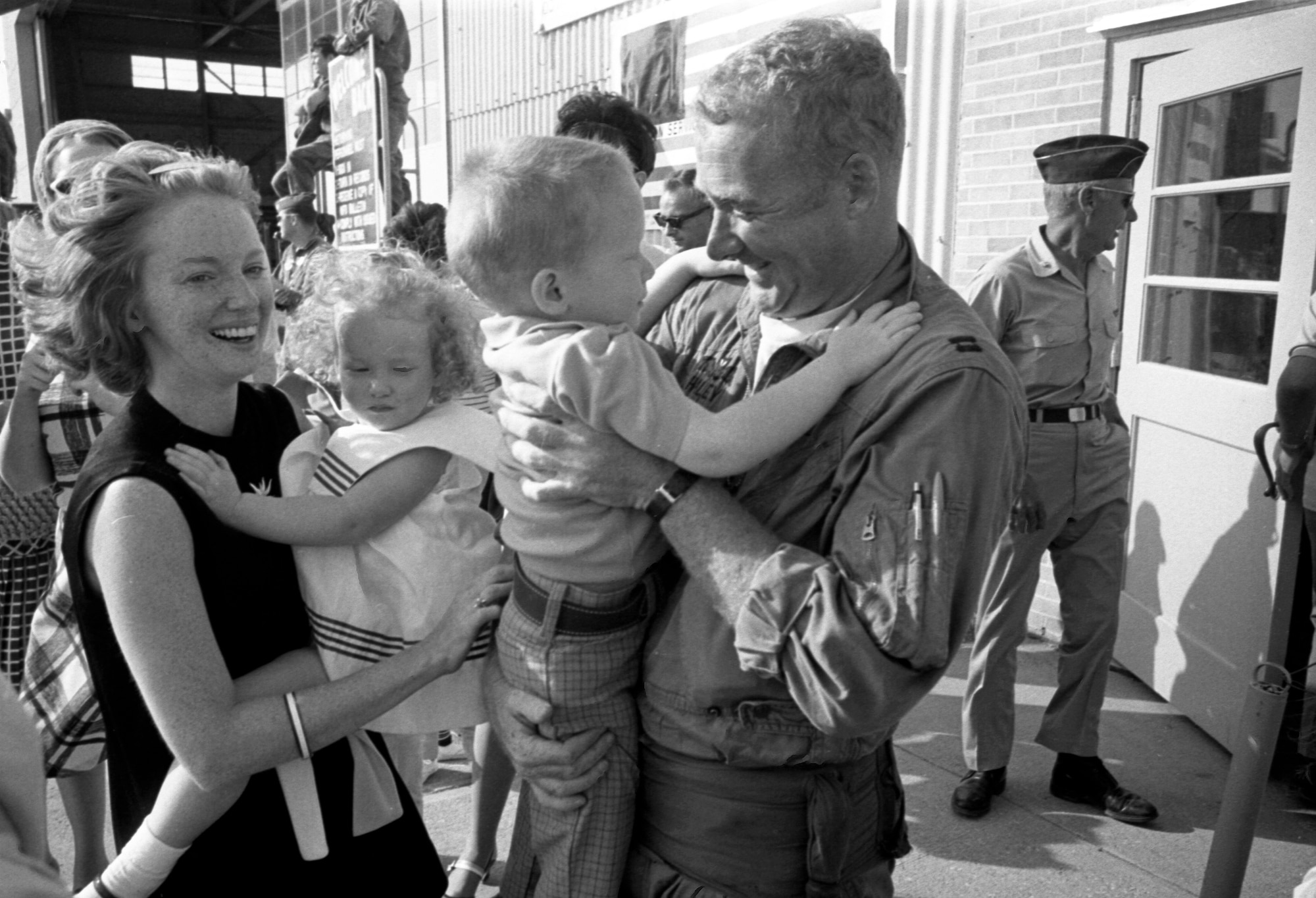 Iowa Air National Guard Captain, John Haley an F-100 fighter pilot with the 185th Tactical Fighter Group is greeted by his family in Sioux City, Iowa on May 14, 1969 after returning home from the war in Vietnam. Haley and the rest of the 185th are returning home from yearlong duty at Phu Cat Airbase in South Vietnam. (U.S. Air National Guard photo/released 185th TFG Photo)
