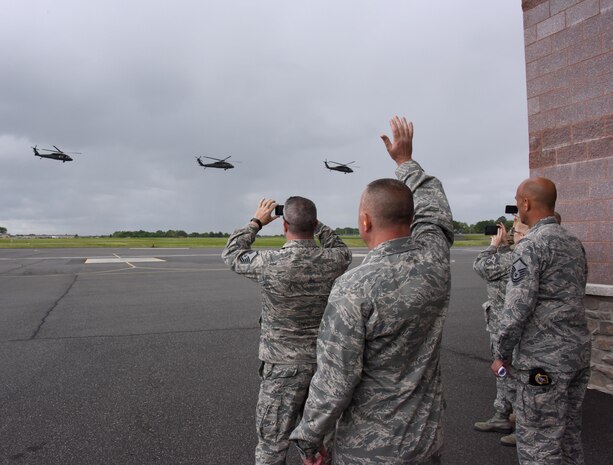ARMY AVIATION SUPPORT FACILITY, Del. - Members of 166th Security Forces Squadron including Commander Lt. Col. Barry Strube along with Delaware National Guard State Command Chief Master Sgt. Patricia Ottinger, wave to their troops as they fly to Joint Base McGuire-Dix Lakehurst, N.J. on May 7, 2017. A four-ship formation of Blackhawk helicopters from the 238th Aviation Regiment, Delaware National Guard, provided airlift of approximately 40 security forces personnel from the DNG Army Aviation Support Facility to Fort Dix. Delaware Air National Guard security defenders will spend eleven days conducting annual training in areas such as: urban combat training, combat life saver training, self-aid buddy care, and weapons qualifications training along with the 87th Security Forces active duty unit. (U.S. Air National Guard photo by Tech. Sgt. Gwendolyn Blakley/Released). 