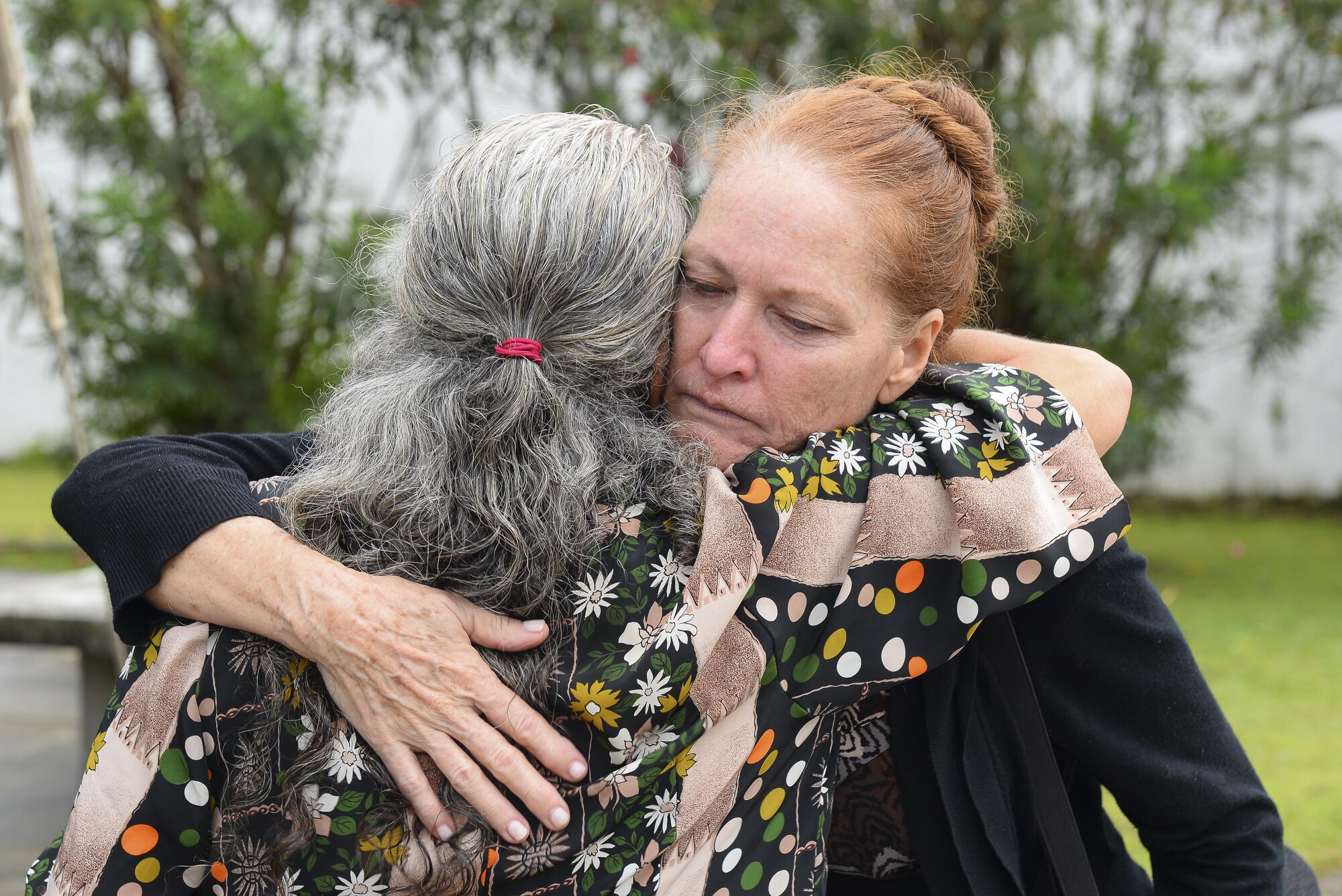 Patricia Gay, 734th Air Mobility Squadron, embraces a friend during Lt Col. (Ret.) Chuck McManus’ funeral at the Guam Veterans Cemetery April 26, 2017, in Piti, Guam. McManus was a key figure at Andersen Air Force Base due to his involvement during the Linebacker II campaign during the Vietnam War. (U.S. Air Force photo by Airman 1st Class Christopher Quail)