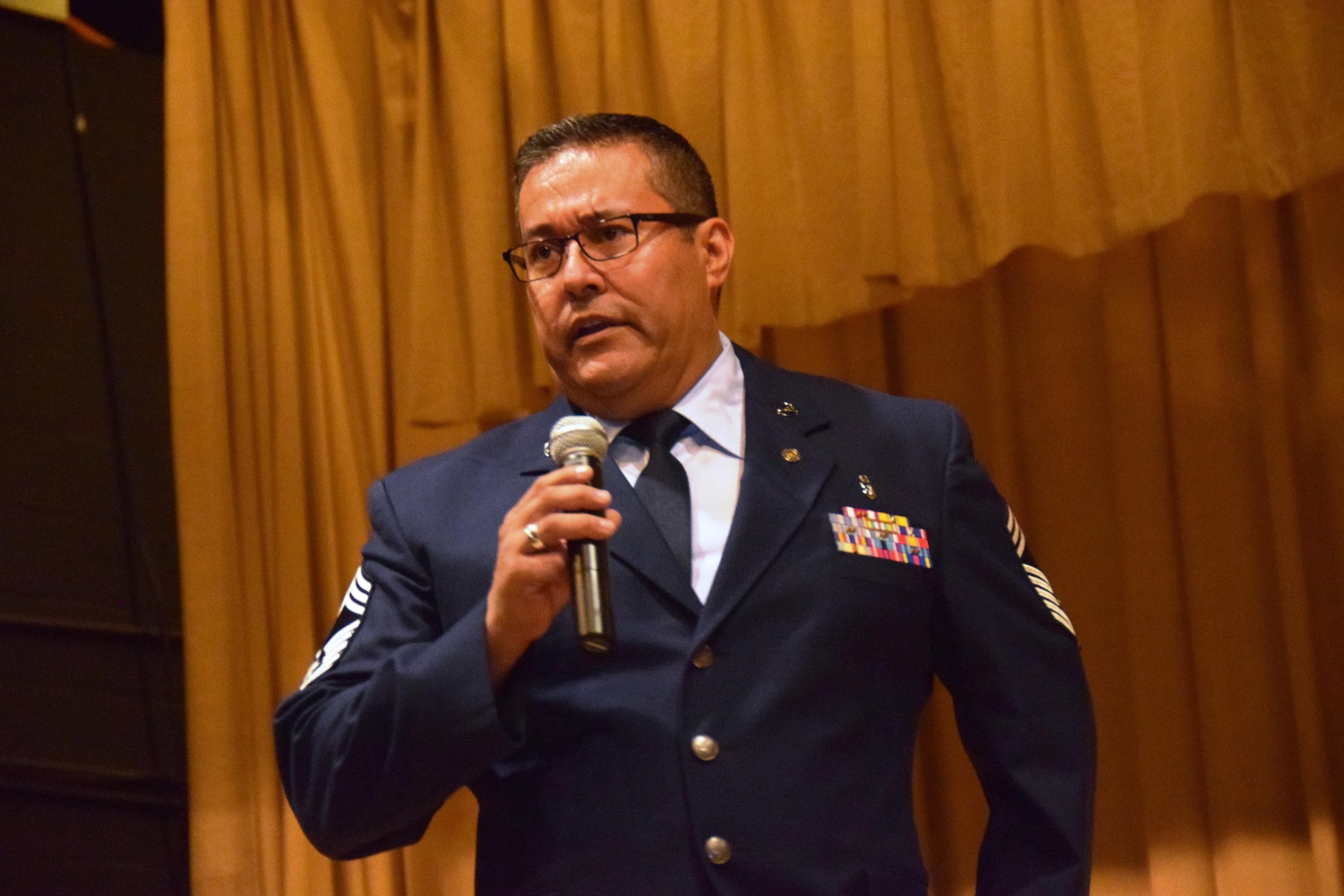 Chief Master Sgt. Christopher E. Florez, addresses the attendees at his retirement ceremony in the Wilford Hall Auditorium at Joint Base San Antonio-Lackland, Texas on May. 7, 2017. The chief began his career with the Alamo Wing as a staff sergeant in 1998. (U.S. Air Force photo by Tech. Sgt. Carlos J. Trevino)