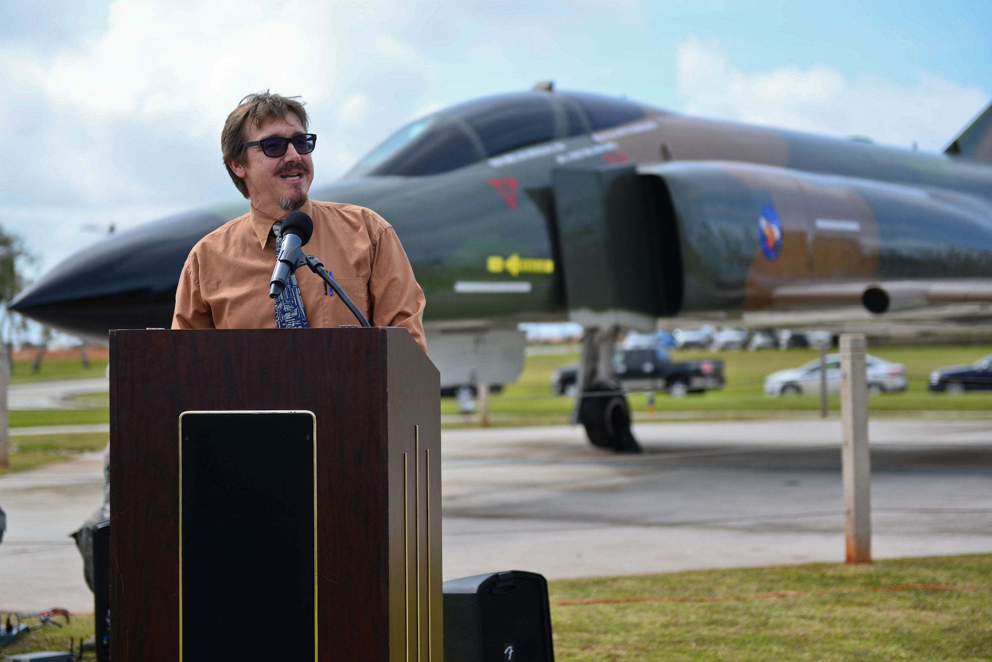 Jeffrey Meyer, 36th Wing Historian, speaks at the F-4E Phantom II Rededication Ceremony, April 21, 2017, at Andersen Air Force Base, Guam. The Phantom II was first deployed to the Pacific Air Forces in December 1964, in support of the Vietnam War. (U.S. Air Force photo by Airman 1st Class Christopher Quail/Released)