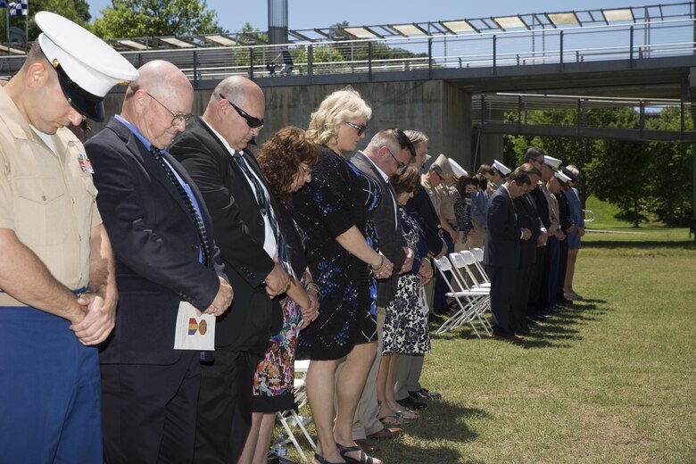 Attendees bow their heads during the invocation at a ceremony posthumously awarding the Navy and Marine Corps Medal to Gunnery Sgt. Thomas Sullivan and Staff Sgt. David Wyatt at Ross’s Landing in Chattanooga, Tenn., May 7, 2017. Sullivan and Wyatt were posthumously awarded the medal for their actions during the July 16, 2015 shooting that occurred at the Naval Reserve Center Chattanooga that left two other Marines and a sailor dead. (U.S. Marine Corps Photo by Lance Cpl. Niles Lee/Released)
