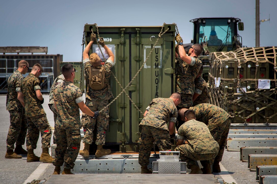 U.S. Marines with III Marine Expeditionary Force, Alert Contingency Marine Air Ground Task Force (ACM) chain down equipment during an ACM drill at Kadena Air Base, Okinawa, Japan, May 5, 2017. The ACM must be prepared to respond within 24 hours to crises throughout the Asian pacific region to mitigate crises, protect U.S. citizens, and territories, or counter threats to U.S. national interests as needed. (U.S. Marine Corps photo by MCIPAC Combat Camera Lance Cpl. Juan C. Bustos)