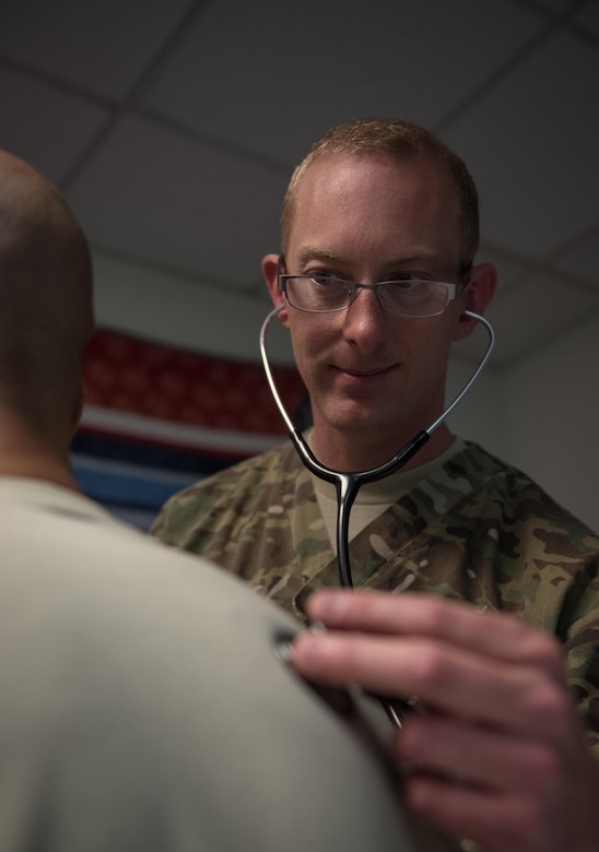 U.S. Air Force Capt. James Dunham, an intensive care ward nurse at Craig Joint Theater Hospital, checks the vitals of a patient at Bagram Airfield, Afghanistan, May 3, 2017. As a nurse, Dunham is the link between the patient and doctor. They are responsible for ensuring medicine is administered, pain is managed and attending to the patient in any way they can. (U.S. Air Force photo by Staff Sgt. Benjamin Gonsier)