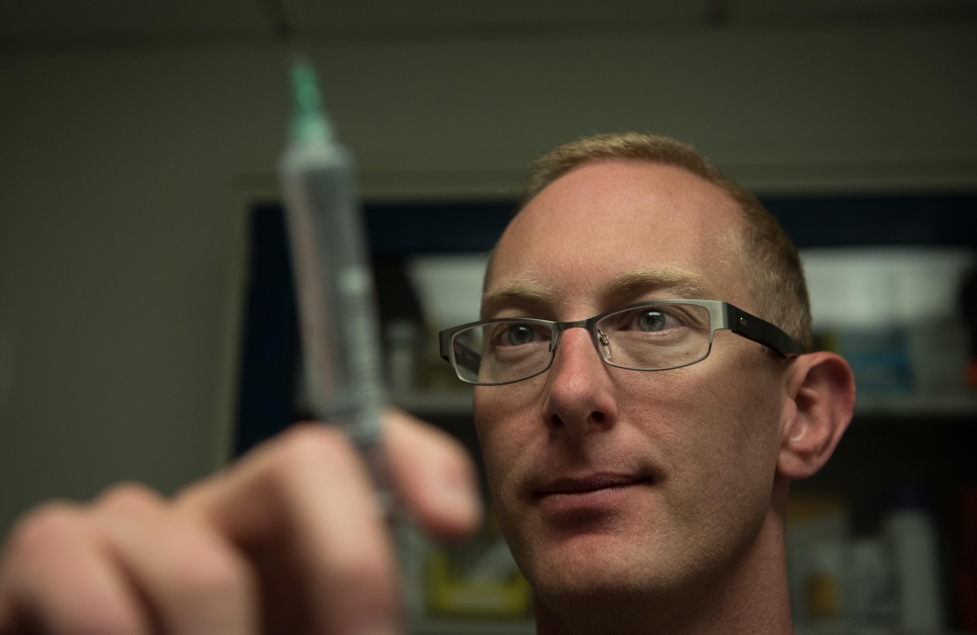 U.S. Air Force Capt. James Dunham, an intensive care ward nurse at Craig Joint Theater Hospital, prepares a syringe at Bagram Airfield, Afghanistan, May 3, 2017. As a nurse, Dunham is the link between the patient and doctor. They are responsible for ensuring medicine is administered, pain is managed and attending to the patient in any way they can. (U.S. Air Force photo by Staff Sgt. Benjamin Gonsier)