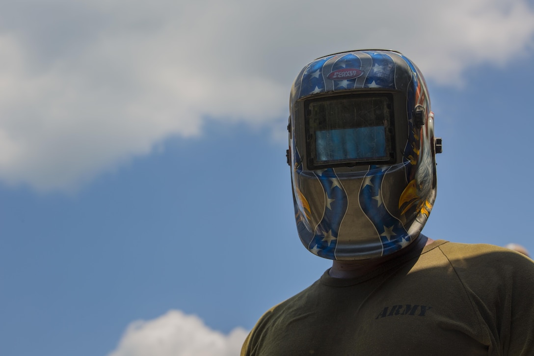 Philippine Army Pfc. Leo Genn Layson stops welding for a picture at Duran Elementary School during a humanitarian civic action project for Balikatan 2017 in Dumalag, Capiz, April 29, 2017. Layson is a welder with the 53rd Engineer Brigade, Philippine Army. Balikatan is an annual U.S.-Philippine bilateral military exercise focused on a variety of missions, including humanitarian assistance and disaster relief, counterterrorism, and other combined military operations. 