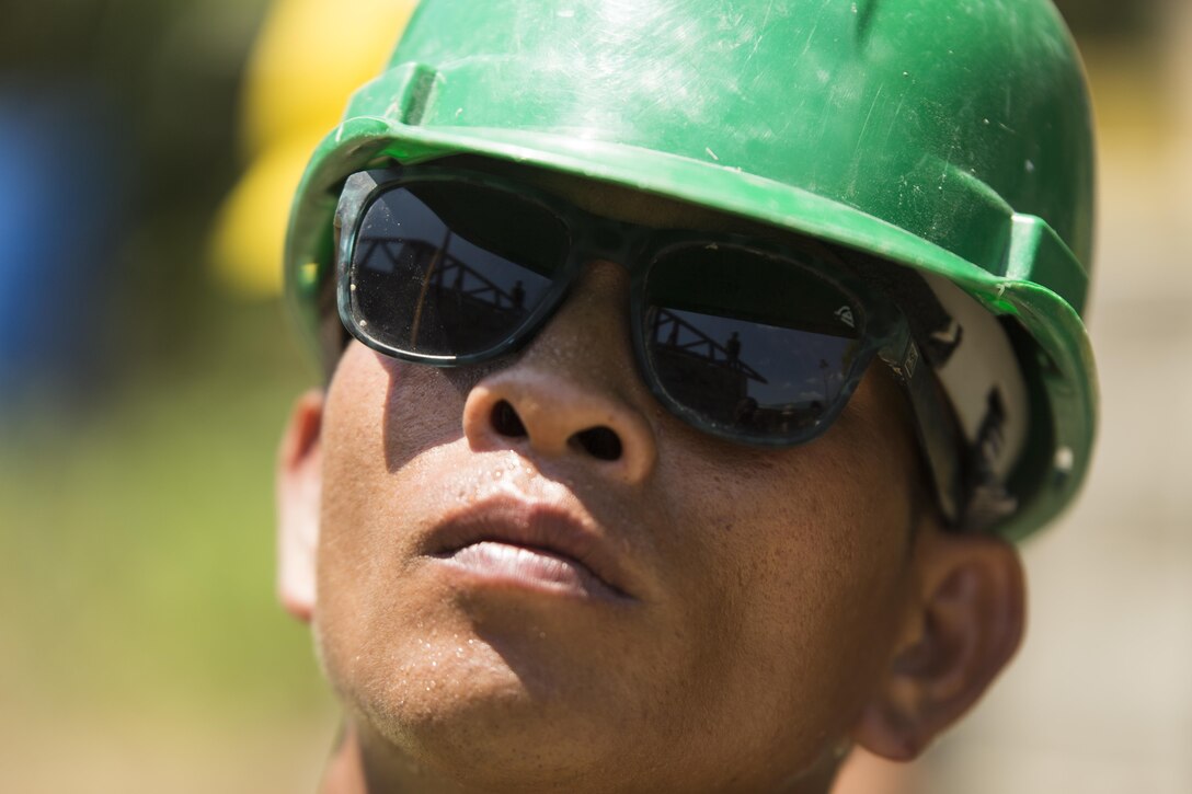 Philippine Army Cpl. Joey Torrefranca watches as U.S and Philippine service members apply a roof’s framework on a school classroom at Duran Elementary School in Dumalag, Capiz, April 29, 2017 as part of a humanitarian civic action project for Balikatan 2017. Torrefranca is a mason with 53rd Engineer Brigade, Philippine Army. Balikatan is an annual U.S.-Philippine bilateral military exercise focused on a variety of missions, including humanitarian assistance and disaster relief, counterterrorism, and other combined military operations. 