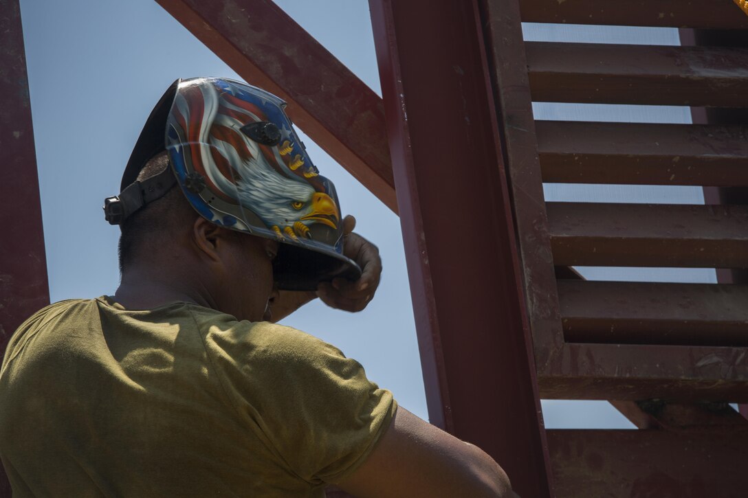 Philippine Army Pfc. Leo Genn Layson removes his welding helmet after working at a construction site for a humanitarian civic action project during Balikatan 2017 at Duran Elementary School in Dumalag, Capiz, April 29, 2017. Layson is a welder with the 53rd Engineer Brigade, Philippine Army. Balikatan is an annual U.S.-Philippine bilateral military exercise focused on a variety of missions, including humanitarian assistance and disaster relief, counterterrorism, and other combined military operations. 