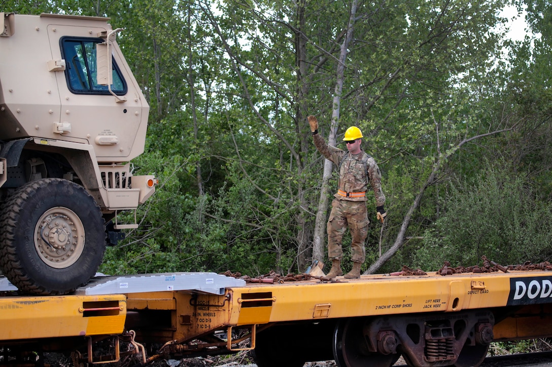 A New Jersey Army National Guardsman directs a vehicle onto a rail car at Morrisville Yard in Morrisville, Pa., May 2, 2017. The soldier is assigned to the New Jersey National Guard’s 50th Infantry Brigade Combat Team. More than 700 vehicles and trailers were placed on the rail cars to be transferred to Fort Pickett, Va., for the Army National Guard’s exportable Combat Training Capability exercise 17-01. Air National Guard photo by Master Sgt. Matt Hecht 