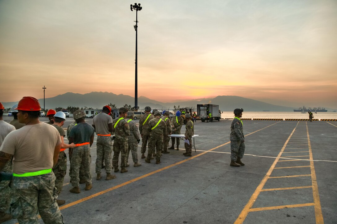 U.S. Soldiers check in before unloading equipment from USNS Fisher (T-AKR 301) during Balikatan 2017 in Subic Bay, Zambales, April 30, 2017. Balikatan is an annual U.S.-Philippine bilateral military exercise focused on a variety of missions, including humanitarian assistance and disaster relief, counterterrorism and other combined military operations.