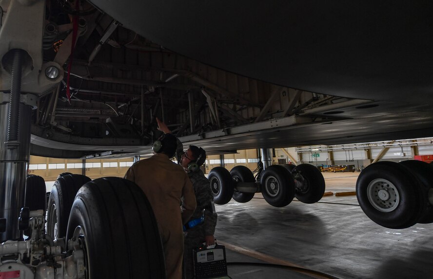 Staff Sgt. Brian Crea, 721st AMXS airlift specialist mission maintenance craftsman, left, and Staff Sgt. Cesar Mardirossian, 60th Aircraft Maintenance Squadron flying crew chief, inspect the nacelle of a C-5M Galaxy on Ramstein Air Base, Germany, May 3, 2017. The aircraft’s number four main landing gear malfunctioned and had to be repaired. Airmen assigned to the 721st AMXS and 60th AMXS towed, jacked, inspected, and repaired the landing gear. (U.S. Air Force Senior Airman Tryphena Mayhugh)