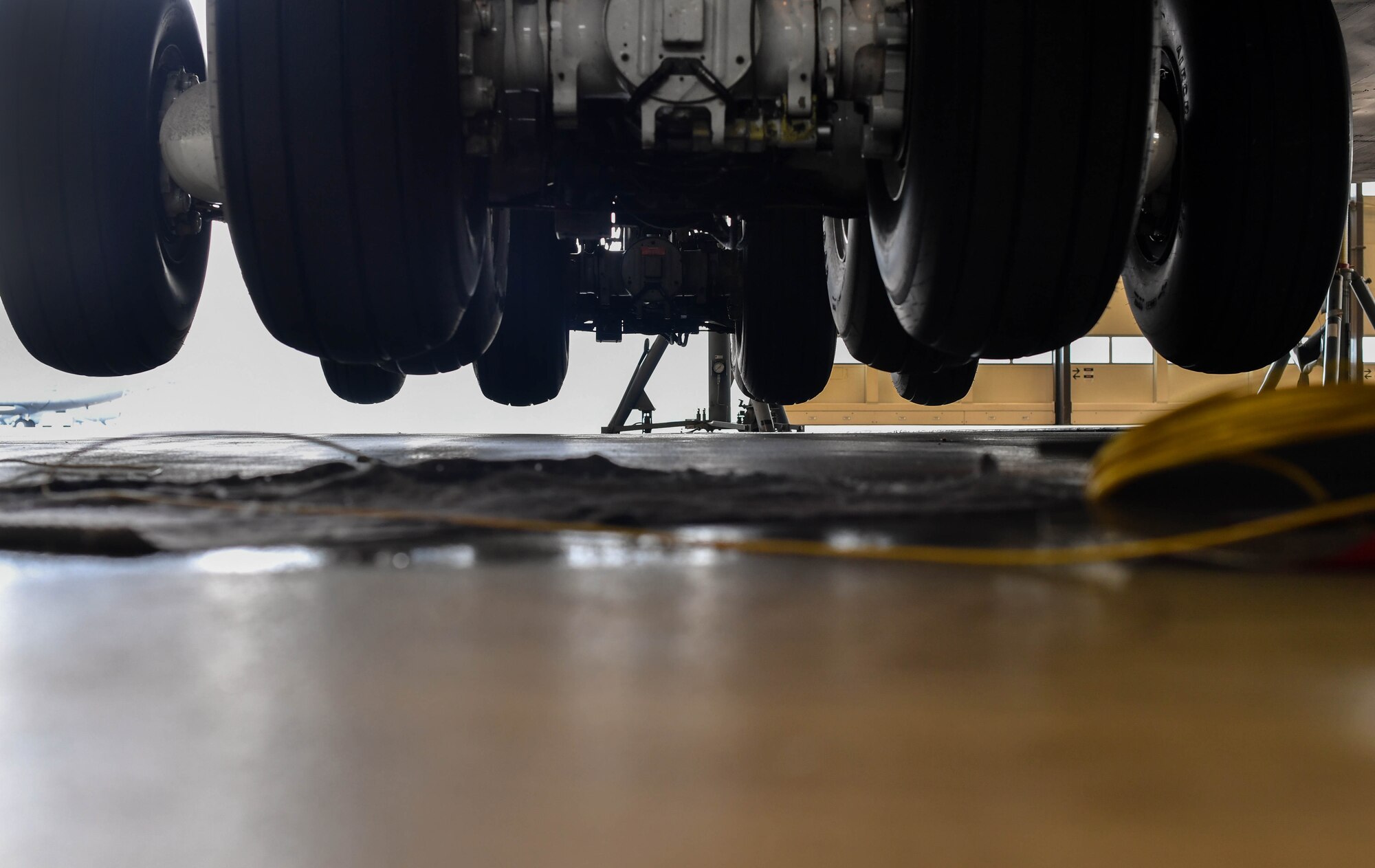 The tires of a C-5M Galaxy’s main landing gear hang several inches off the ground as the aircraft rests on six fuselage jacks on Ramstein Air Base, Germany, May 3, 2017. Each jack can hold up to 60 tons, equaling 720,000 pounds, and a typical C-5 weighs 415,000 pounds. The aircraft was jacked to inspect and repair the number four main landing gear. (U.S. Air Force Senior Airman Tryphena Mayhugh)
