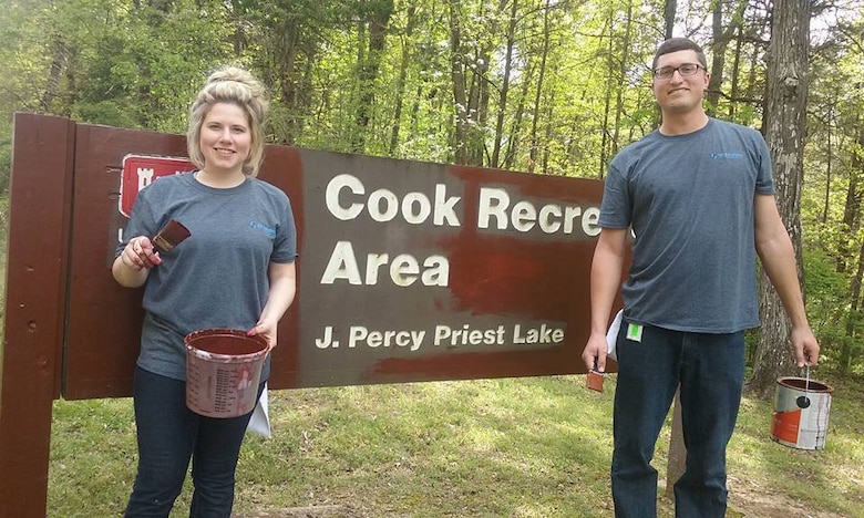 Logan Palmer (left) and Taylor Fly, both volunteers from VF Imagewear, INC., paint an entry sign at the Cook Recreation Area during a lake clean up J. Percy Priest Lake on April 13, 2017.  72 volunteers participated and helped paint, plant trees and clear debris at the Lake.    