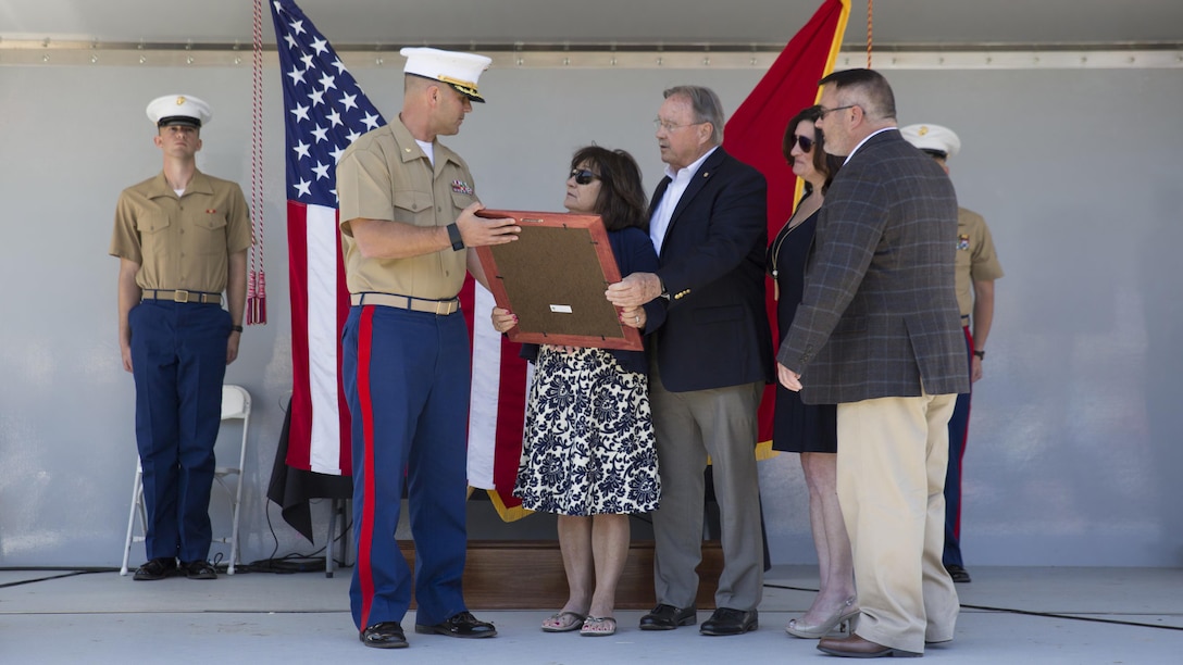 Maj. Chris Cotton, commanding officer of Recruiting Station Montgomery, presents the Navy and Marine Corps Medal to the family of Gunnery Sgt. Thomas Sullivan, at Ross’s Landing in Chattanooga, Tenn., May 7, 2017. Cotton is the former Inspector-Instructor for Battery M, 3rd Battalion, 14th Marine Regiment, 4th Marine Division, Marine Forces Reserve, the unit that Sullivan was assigned to. 