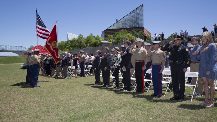 Attendees stand for the posting of the colors during a ceremony posthumously awarding the Navy and Marine Corps Medal to Gunnery Sgt. Thomas Sullivan and Staff Sgt. David Wyatt at Ross’s Landing in Chattanooga, Tenn., May 7, 2017. Attendees of the ceremony included Maj. Gen. Burke W. Whitman, commanding general of 4th Marine Division, Sgt. Maj. Michael A. Miller, sergeant major of 4th MARDIV and family members of GySgt Thomas Sullivan and SSgt David Wyatt. 