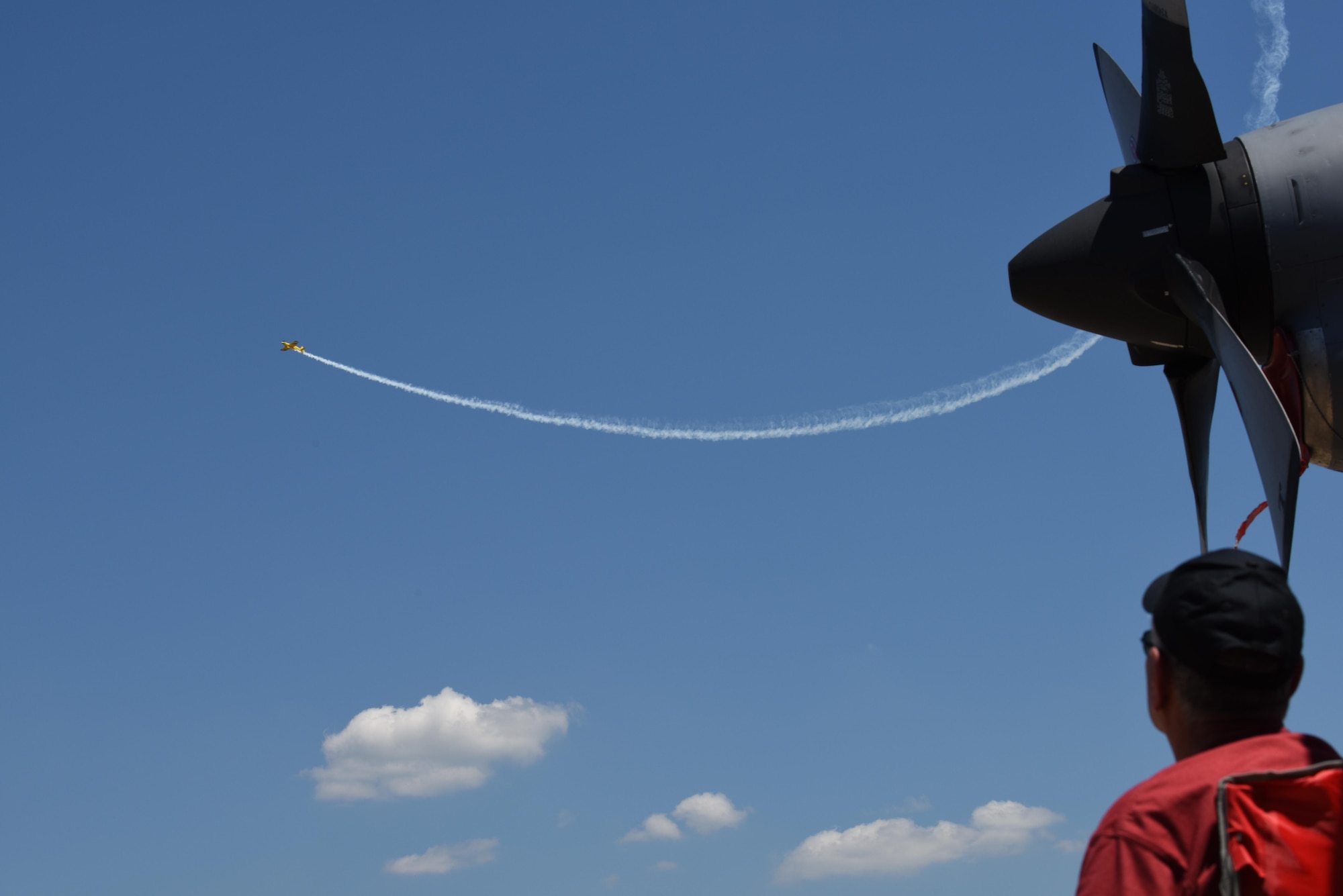 A spectator watches Kevin Coleman’s stunt plane during the 2017 Defenders of Liberty Air Show at Barksdale Air Force Base, La., May 7. The air show boasted a variety of aircraft performances and displays as well as inflatables for children. (U.S. Air Force photo/Senior Airman Luke Hill)