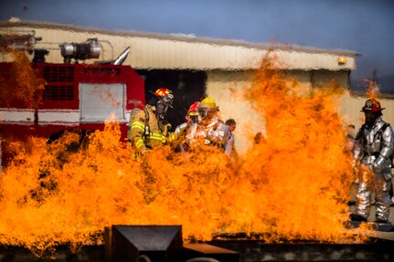 Firefighters from Central America learn new fire hose techniques at a live fire exercise during Central America Sharing Mutual Operational and Experience at Joint Task Force – Bravo, Apr. 26, 2017. CENTAM SMOKE is a biannual exercise hosted by Joint Task Force – Bravo with 35 participants from across the 7 Central America nations that includes safety, personal protective equipment, apparatus familiarization, fire hose applications, structural/helicopter live fire evolutions, medical training, vehicle extrication, and aircraft (UH–60/CH–47) egress familiarization, Apr. 24-28, 2017. (U.S. Air National Guard photo by Master Sgt. Scott Thompson/released)