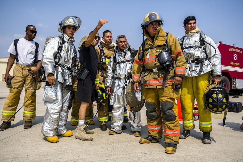 An instructor describes the live fire exercise to firefighters from Central America during Central America Sharing Mutual Operational and Experience at Joint Task Force – Bravo, Apr. 26, 2017. CENTAM SMOKE is a biannual exercise hosted by Joint Task Force – Bravo with 35 participants from across the 7 Central America nations that includes safety, personal protective equipment, apparatus familiarization, fire hose applications, structural/helicopter live fire evolutions, medical training, vehicle extrication, and aircraft (UH–60/CH–47) egress familiarization, Apr. 24-28, 2017. (U.S. Air National Guard photo by Master Sgt. Scott Thompson/released)