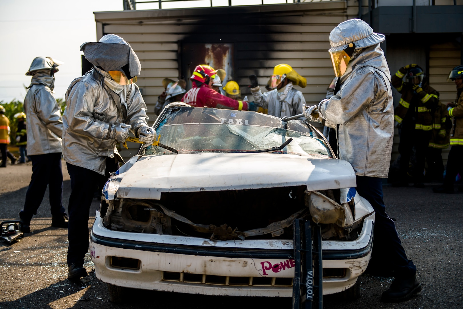 Firefighters from Costa Rica watch participants learn new techniques during Central America Sharing Mutual Operational and Experience at Joint Task Force – Bravo, Apr. 25, 2017. CENTAM SMOKE is a biannual exercise hosted by Joint Task Force – Bravo with 35 participants from across the 7 Central America nations that includes safety, personal protective equipment, apparatus familiarization, fire hose applications, structural/helicopter live fire evolutions, medical training, vehicle extrication, and aircraft (UH–60/CH–47) egress familiarization, Apr. 24-28, 2017. (U.S. Air National Guard photo by Master Sgt. Scott Thompson/released)