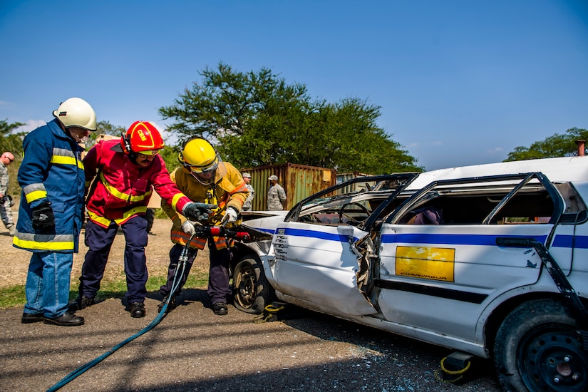 Firefighters from Central America learn new vehicle extraction techniques at Central America Sharing Mutual Operational and Experience at Joint Task Force – Bravo, Apr. 27, 2017. CENTAM SMOKE is a biannual exercise hosted by Joint Task Force – Bravo with 35 participants from across the 7 Central America nations that includes safety, personal protective equipment, apparatus familiarization, fire hose applications, structural/helicopter live fire evolutions, medical training, vehicle extrication, and aircraft (UH–60/CH–47) egress familiarization, Apr. 24-28, 2017. (U.S. Air National Guard photo by Master Sgt. Scott Thompson/released)